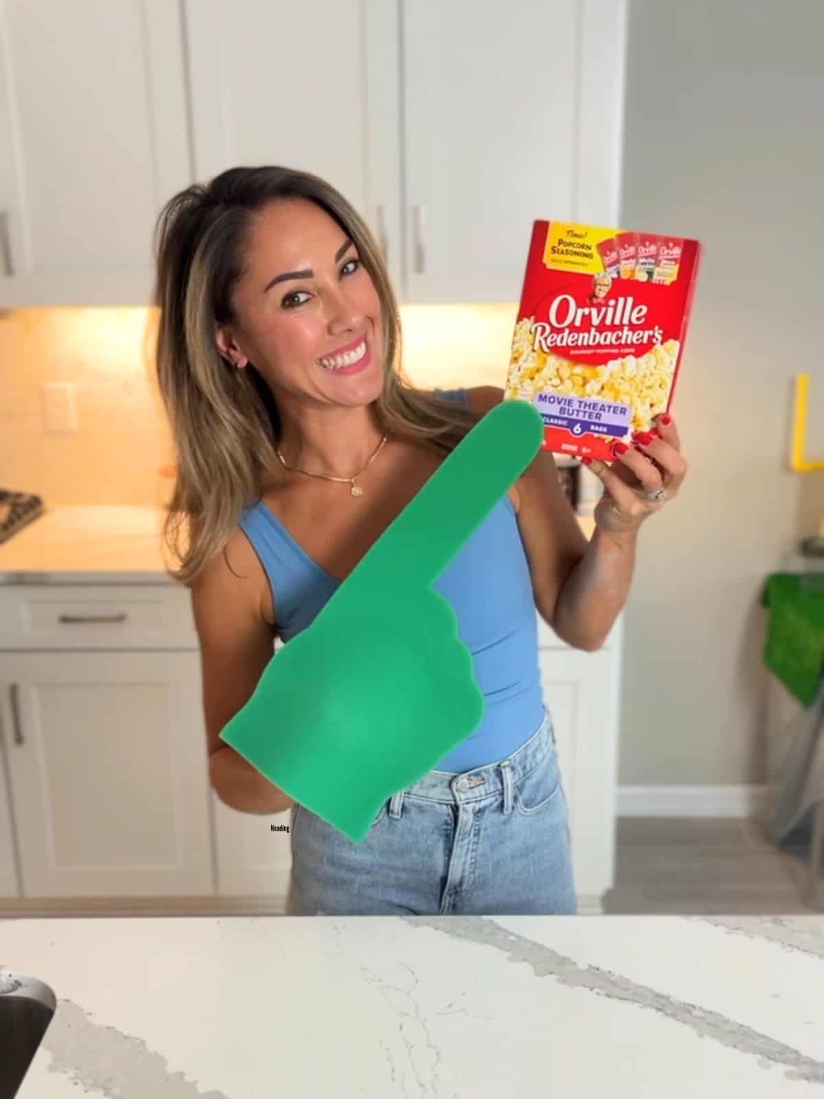 Aleka holding popcorn box.