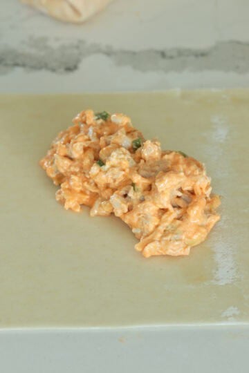 Buffalo chicken mixture in a wrapper.