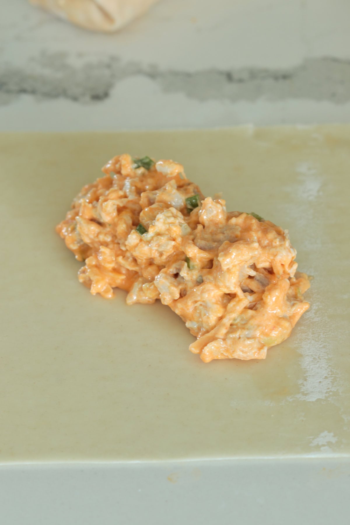 Buffalo chicken filling on wonton.