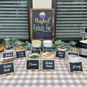 Mashed potato bar with toppings on table.