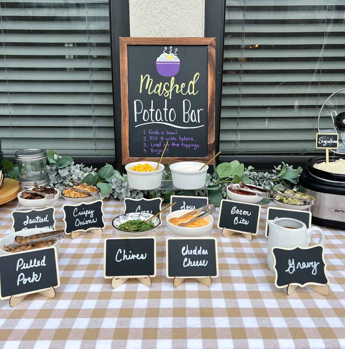 Mashed potato bar with toppings on a table.