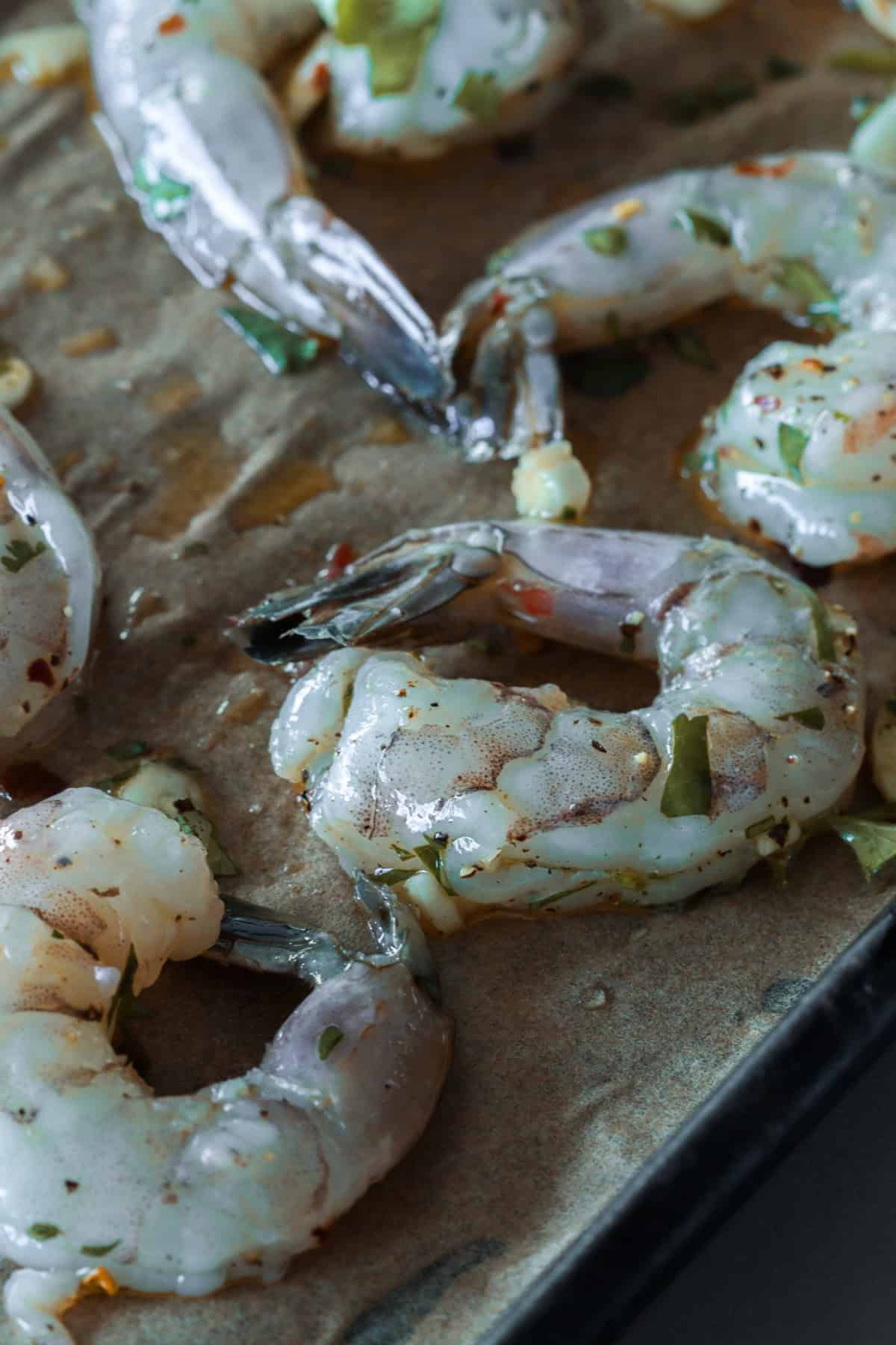 Raw shrimp cocktail on sheetpan before baking.