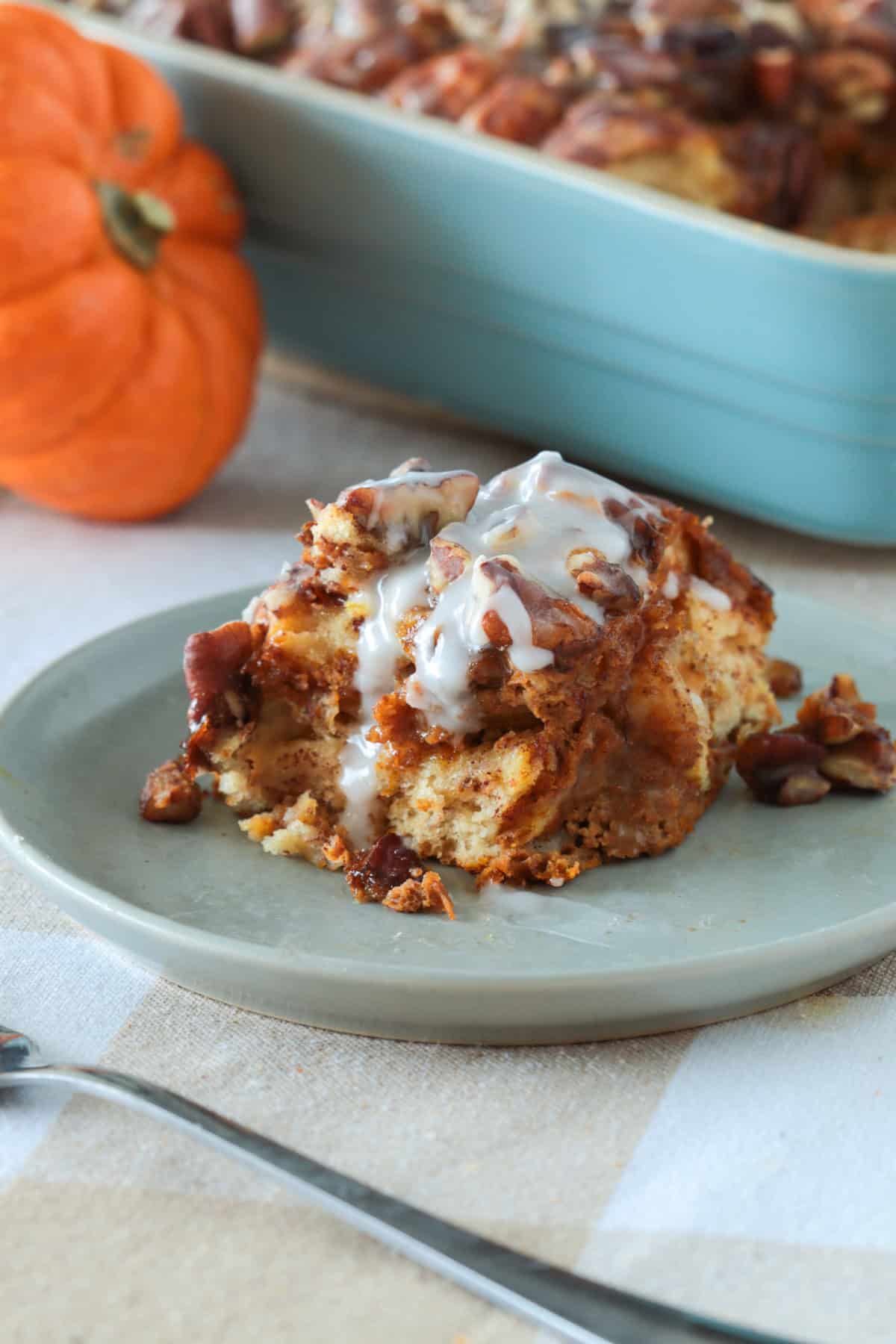 Slice of pupmkin cinnamon roll casserole on a plate.