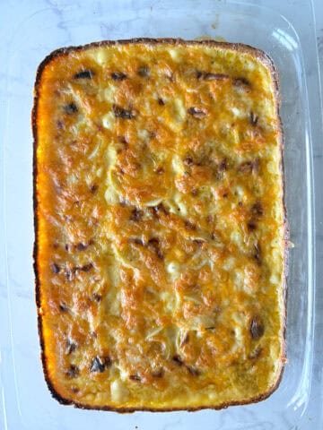 Baked potatoes with cheese on top.