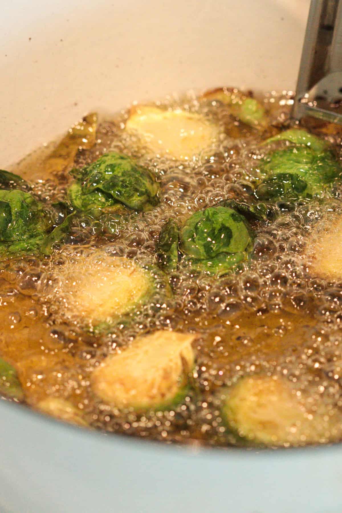 Frying brussels sprouts.