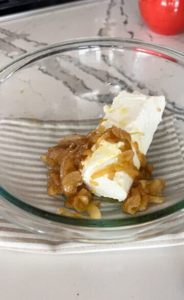 Goat cheese added to caramel brown onion.