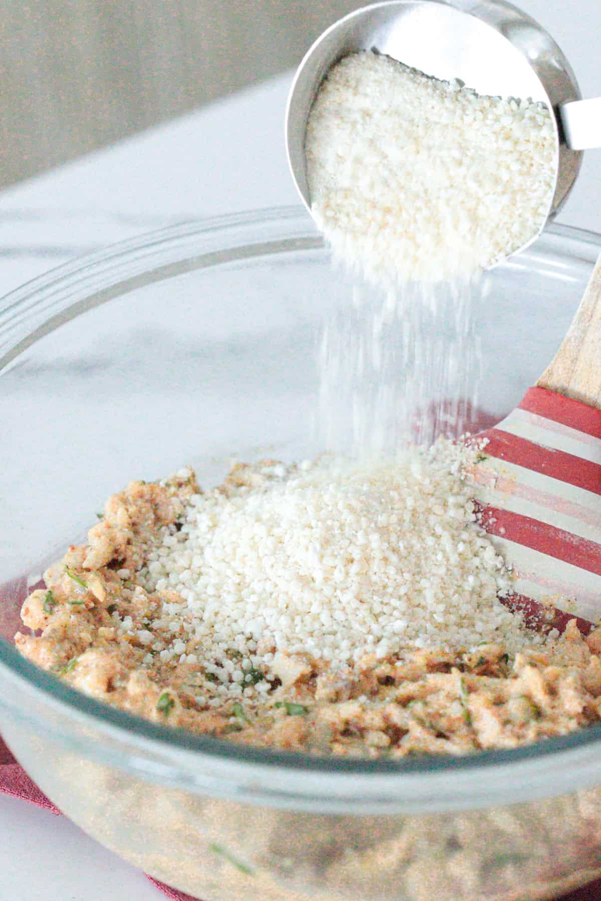 Adding breadcrumbs to bowl.