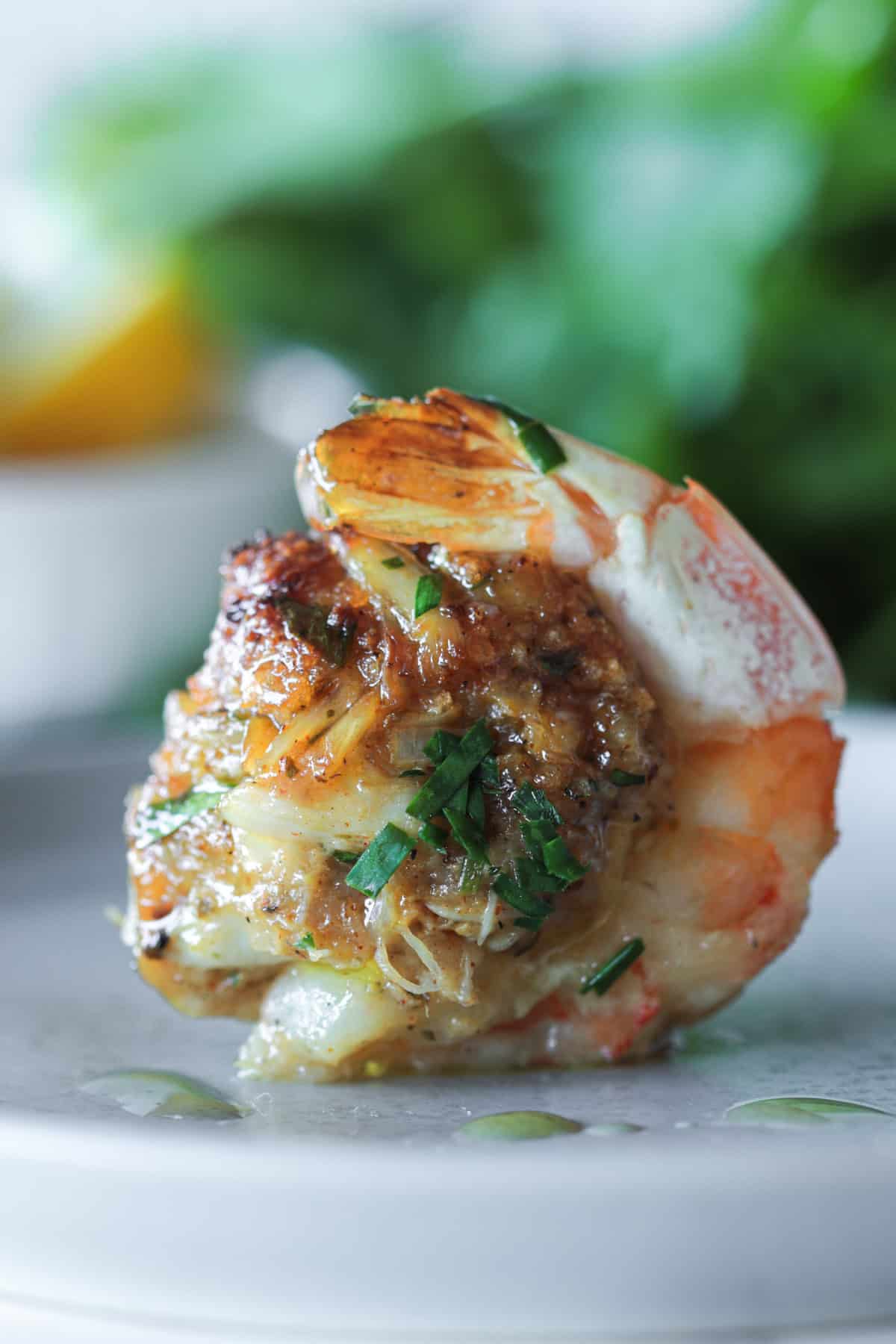 Stuffed shrimp with crab sitting on a plate.