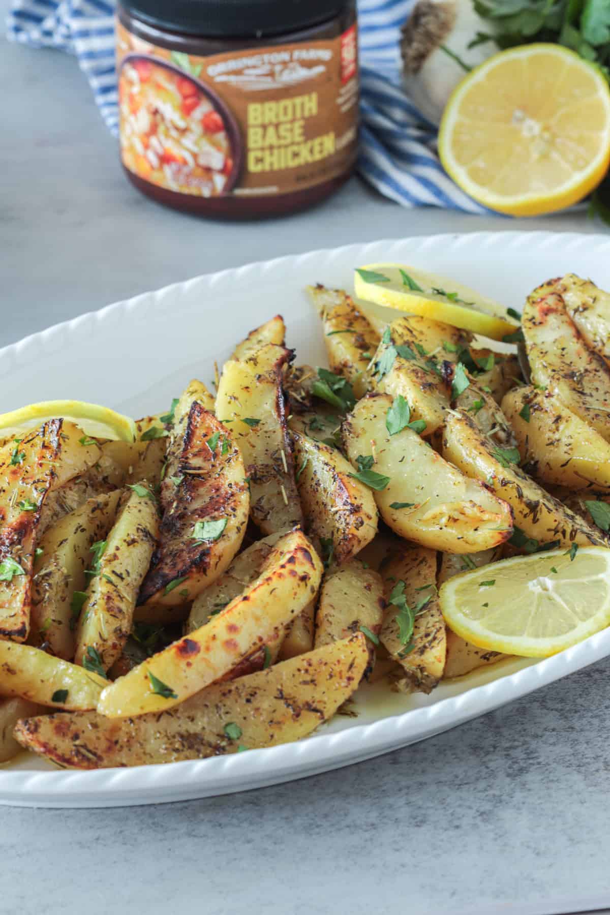 Greek lemon potatoes in a casserole dish with lemon slices.