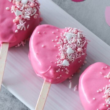 Heart cake pop on plate.