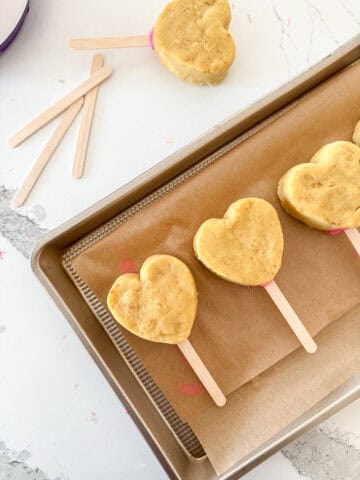 Heart-shaped cake with popsicle stick.