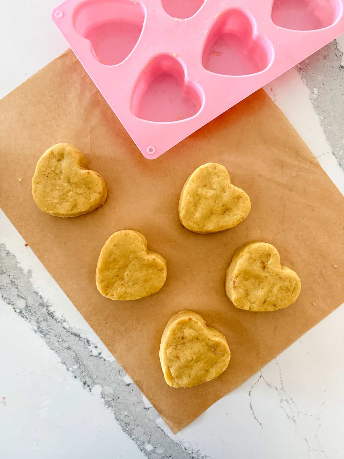 Heart cake molds on parchment paper.