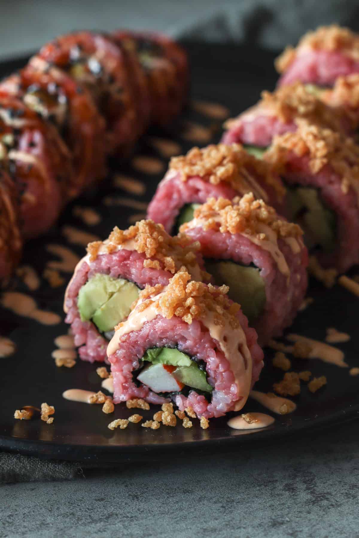 Pink crunch roll on plate.