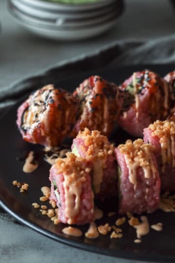 Sushi drizzled with sauce.
