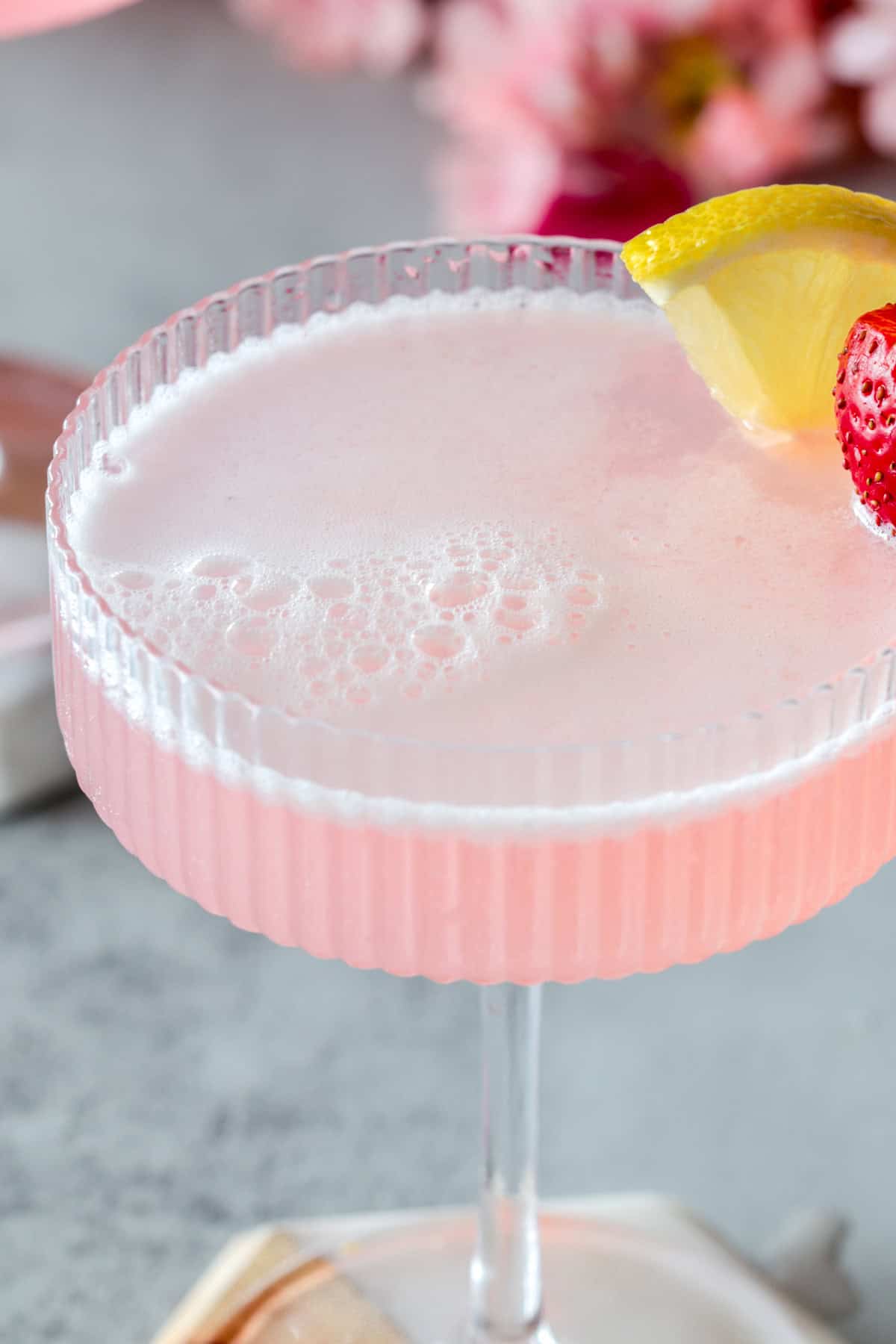 Pink drink in a coupe glass.