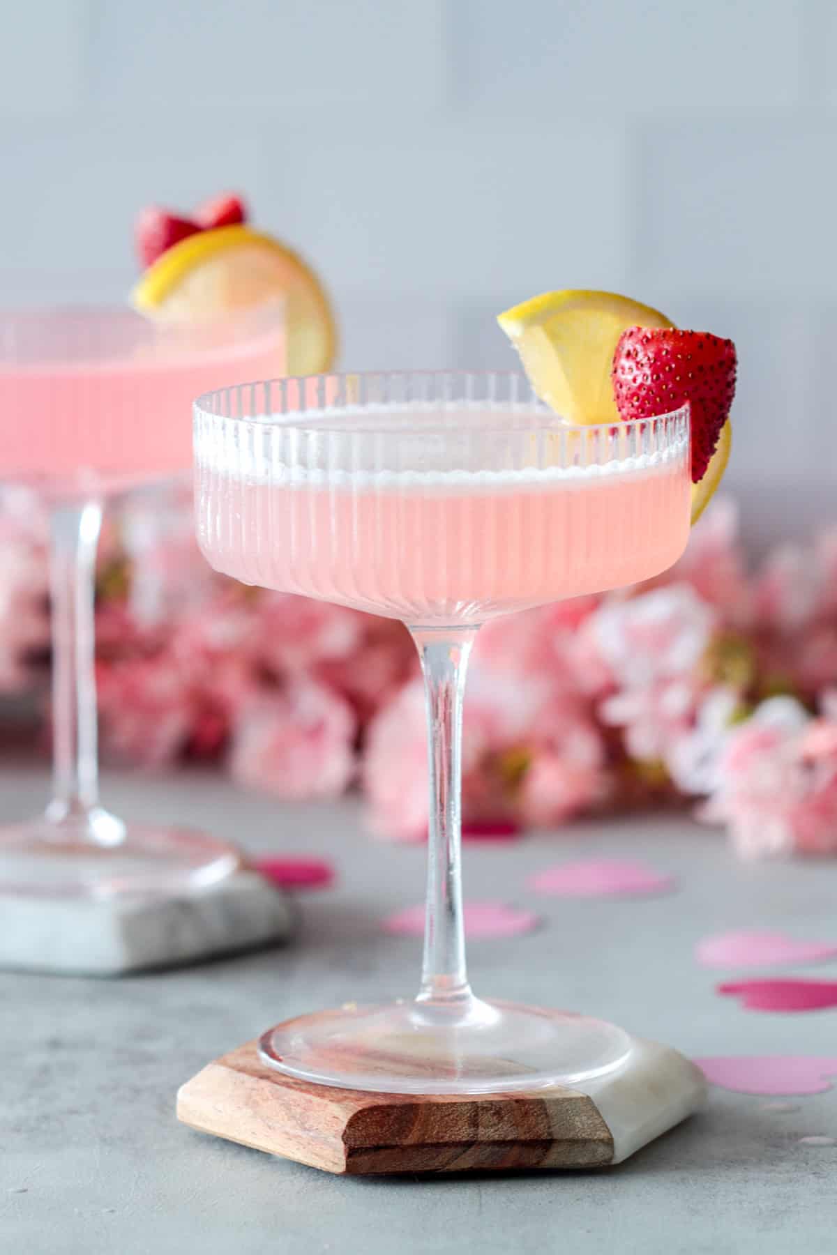 Pink vodka cocktail in a coupe glass.