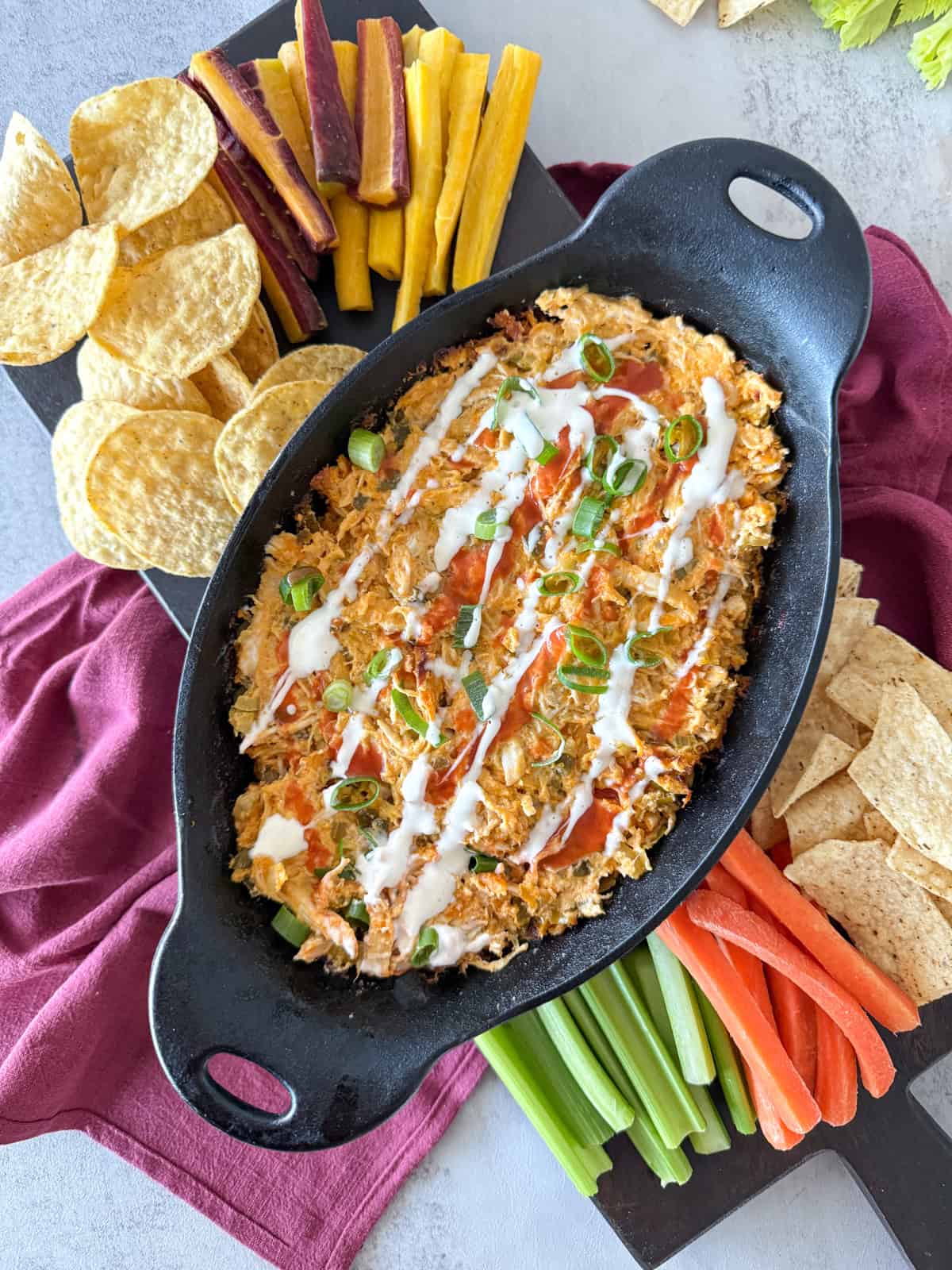 Dairy free buffalo chicken dip in cast iron skillet.