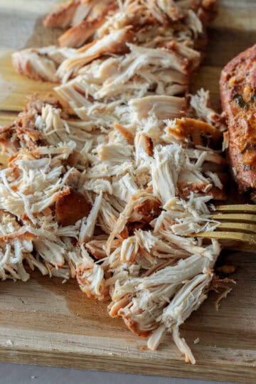 Shredded chicken breast using fork.