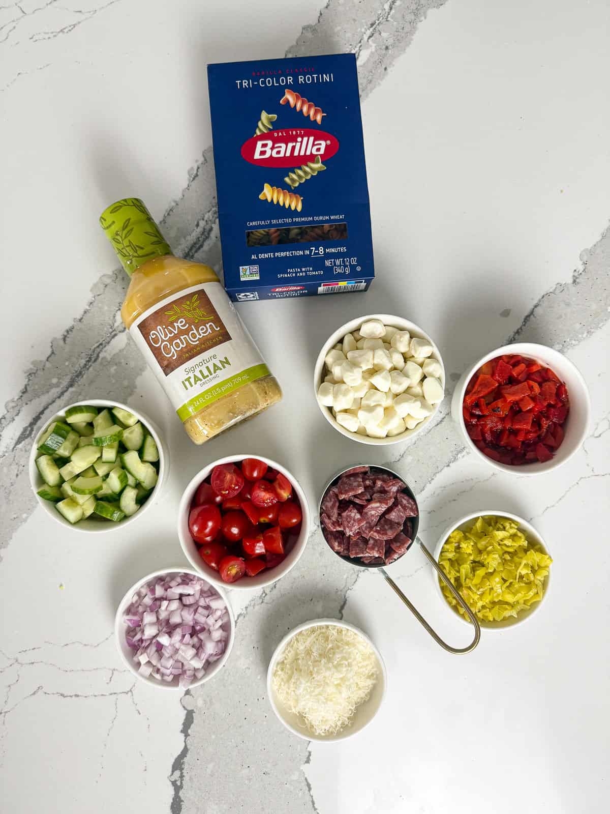Ingredients for Italian pasta salad on table.