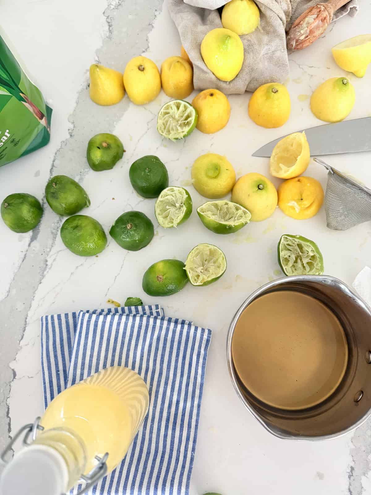 Squeezed lemons and limes on table.