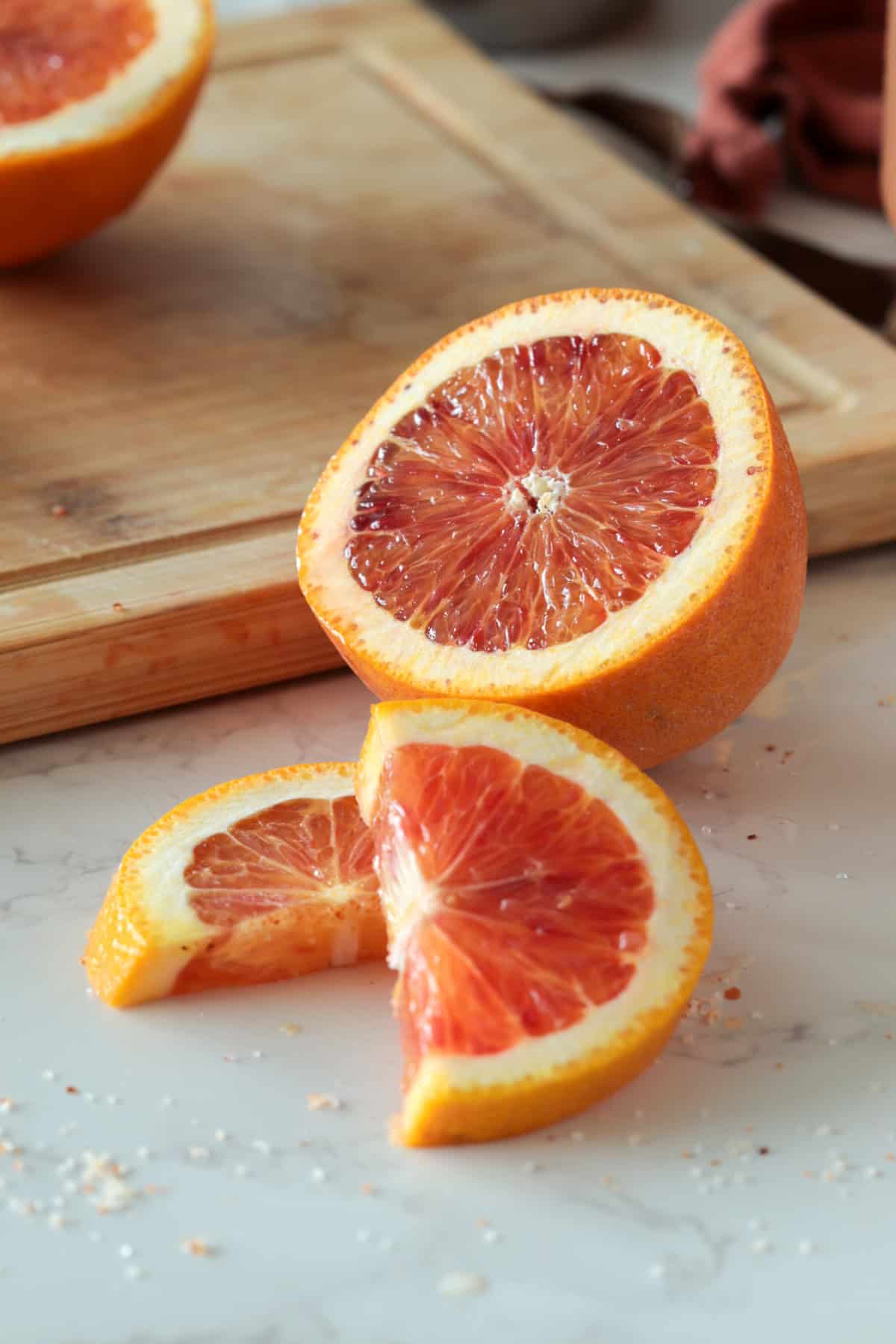 Blood orange cut on a cutting board.