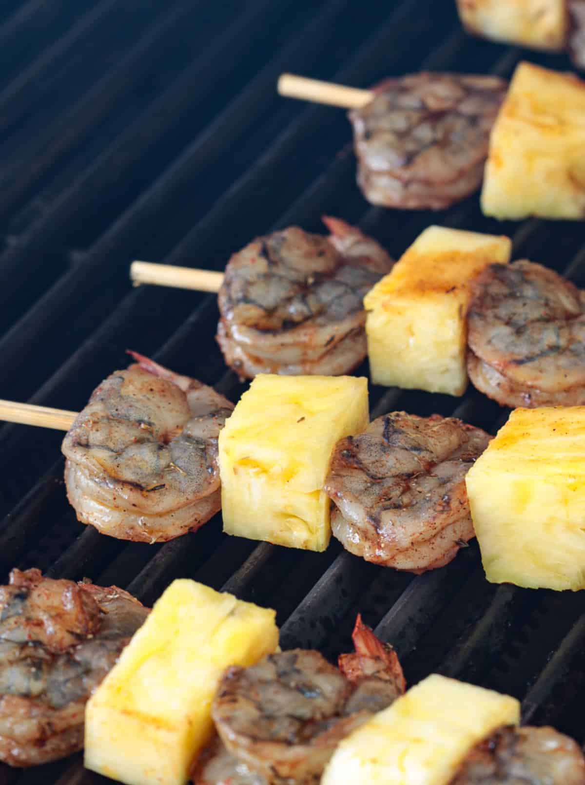 Pineapple shrimp skewers on grill.
