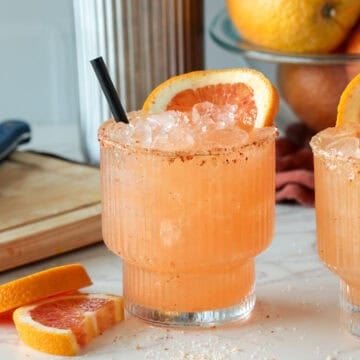 Blood orange margarita with orange slice.