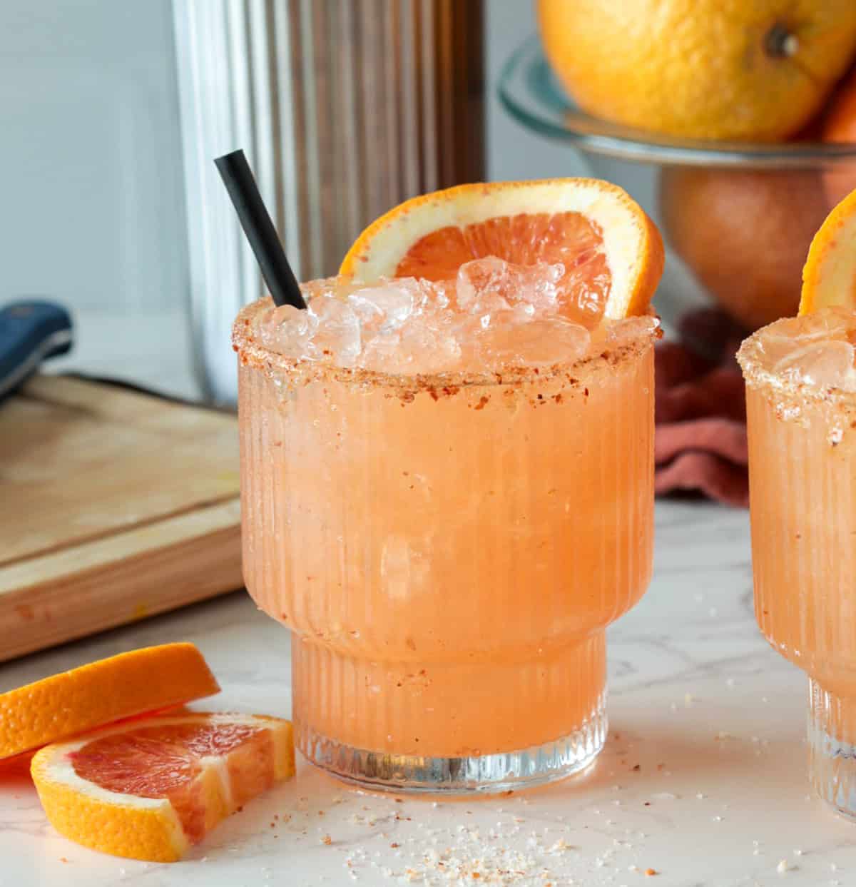 Blood orange margarita with orange slice.