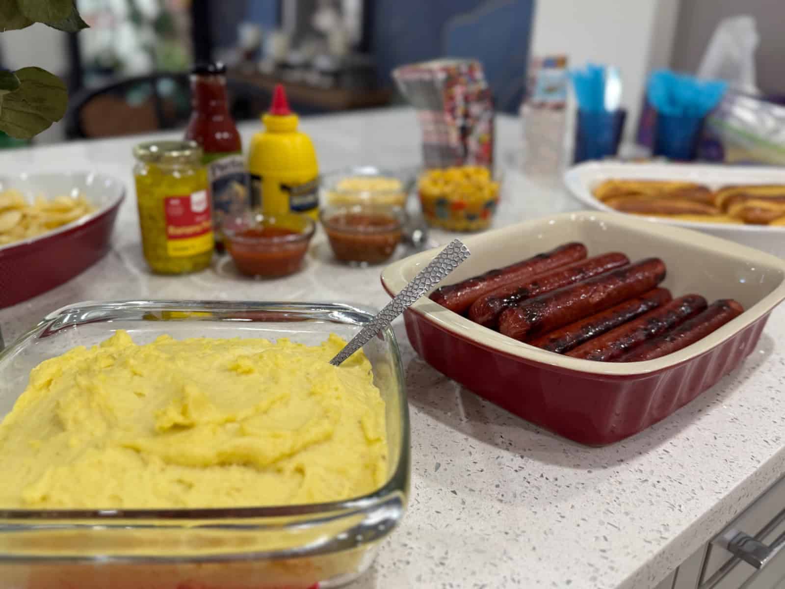 Friends celebrating a soccer watch party with Brazilian hot dogs and international decorations