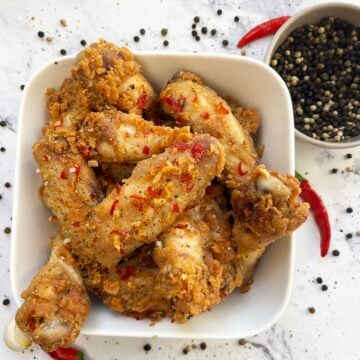 Crispy salt and pepper chicken wings with red chiles and peppercorns.