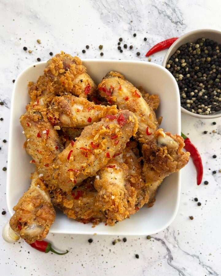 Crispy salt and pepper chicken wings with red chiles and peppercorns.