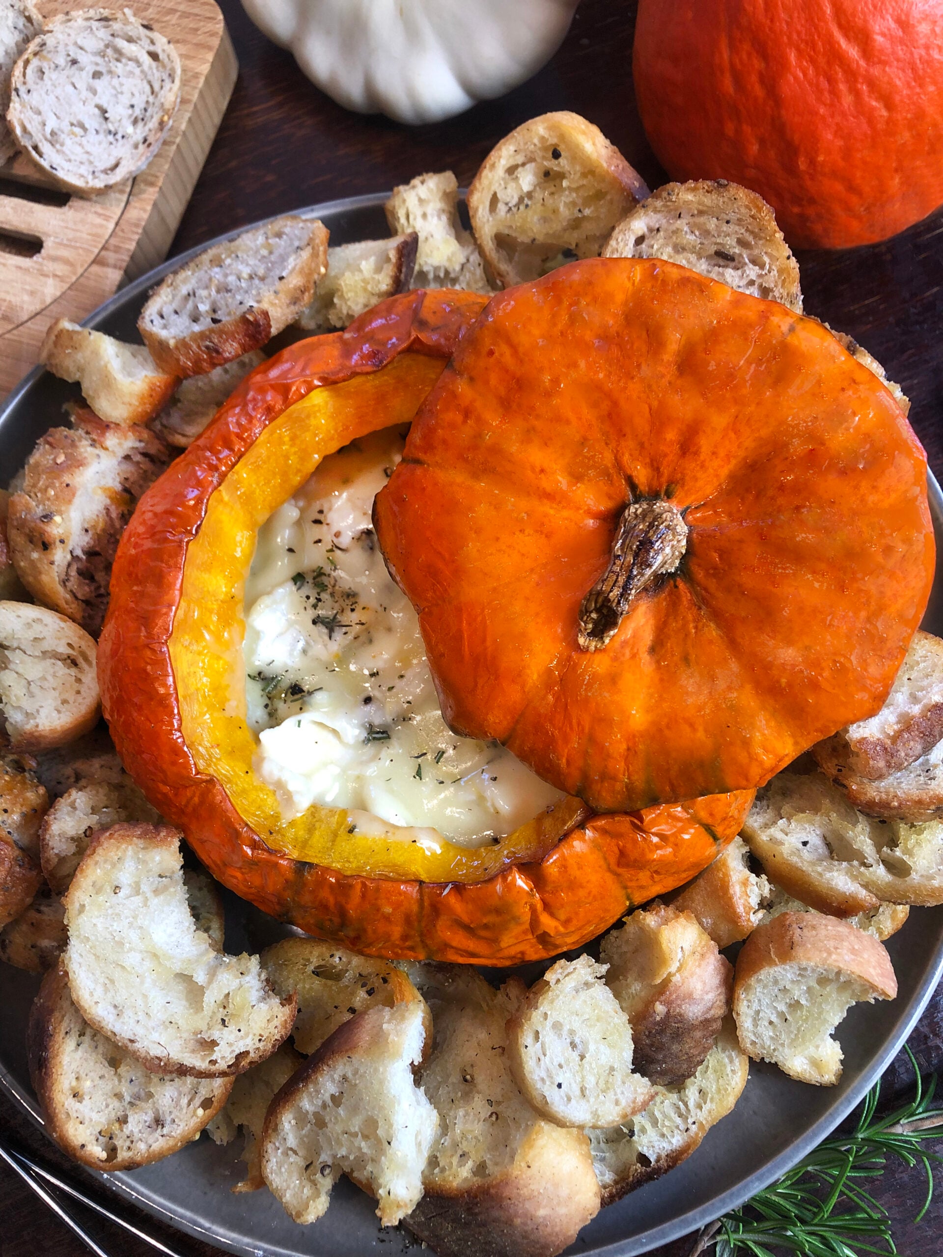 Pumpkin Brie fondue served with the roasted pumpkin lid and toasted bread.