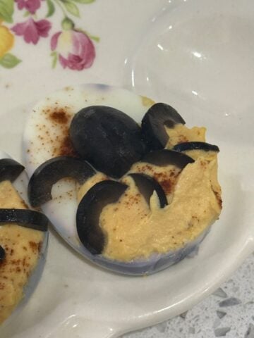 Black olive spider on creamy Halloween deviled egg filling