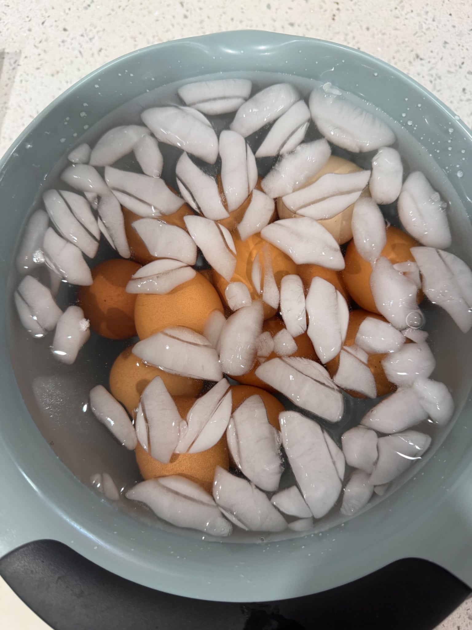 Hard-boiled eggs cooling immediately in a bowl of ice water